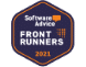 Alt text: Hexagonal badge with a dark blue background and an orange border, displaying the text "Software Advice" accompanied by an orange chat bubble. Below, it reads "FRONT RUNNERS 2021" in white and orange text. A subtle grid pattern is visible on the right side of the badge.